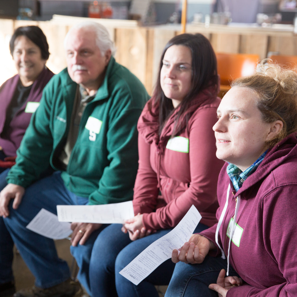 Meditation Globe class students attentively listen to a glassblower's glassblowing safety demonstration.