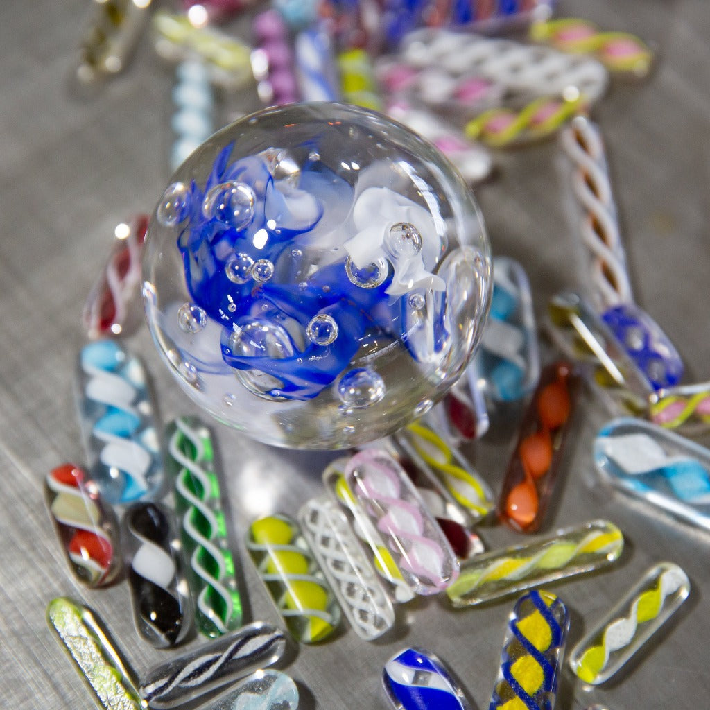 An example of the a blue and white meditation globe from the intro/beginners glass blowing class at the Glass Academy