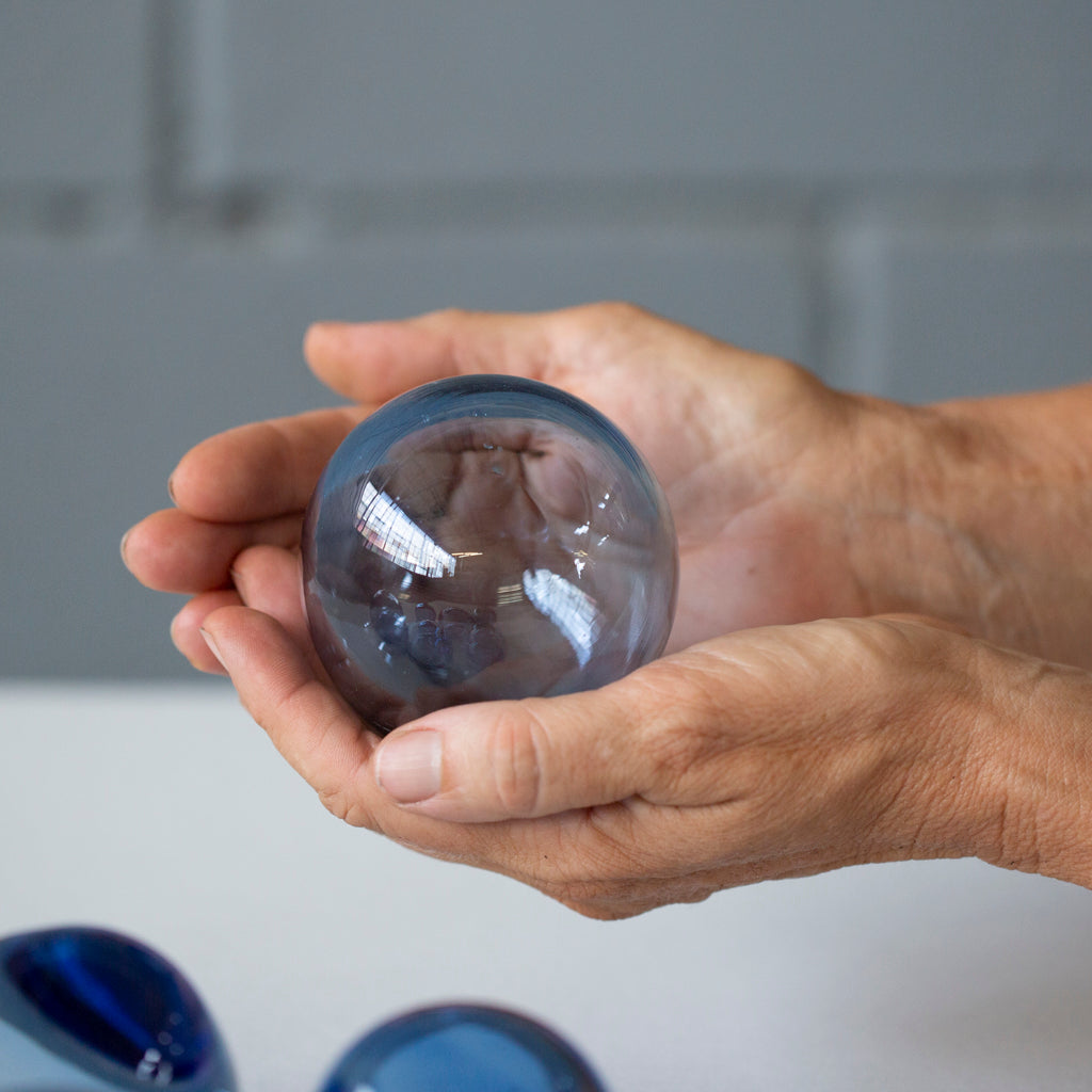 Two hands hold a Breath of Michigan Bubble.