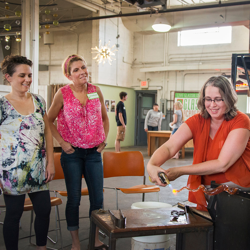 Students at the Glass Academy use a torch to create a percolla reed out of molten glass