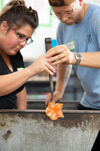 One of our students learning how to blow glass
